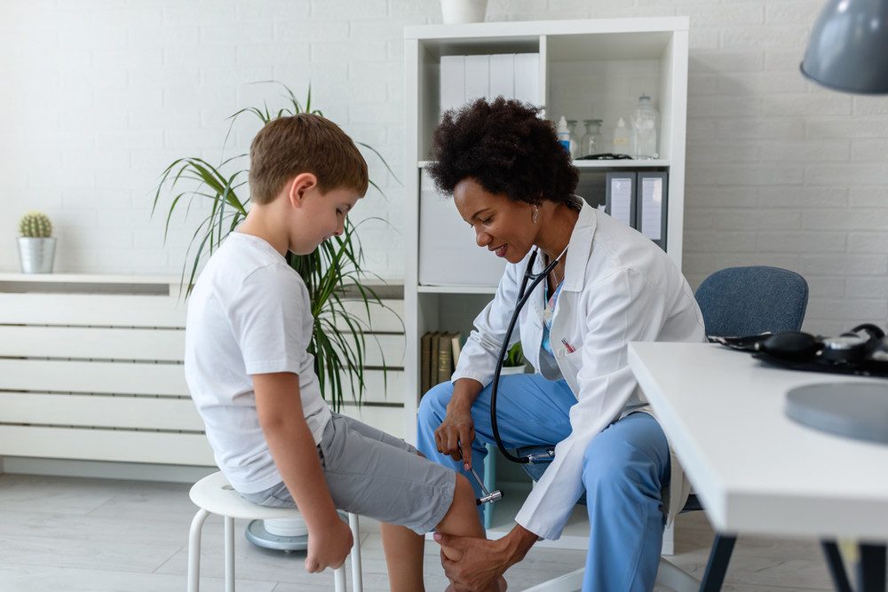 A clinician examining a patient's knee during a fitting.